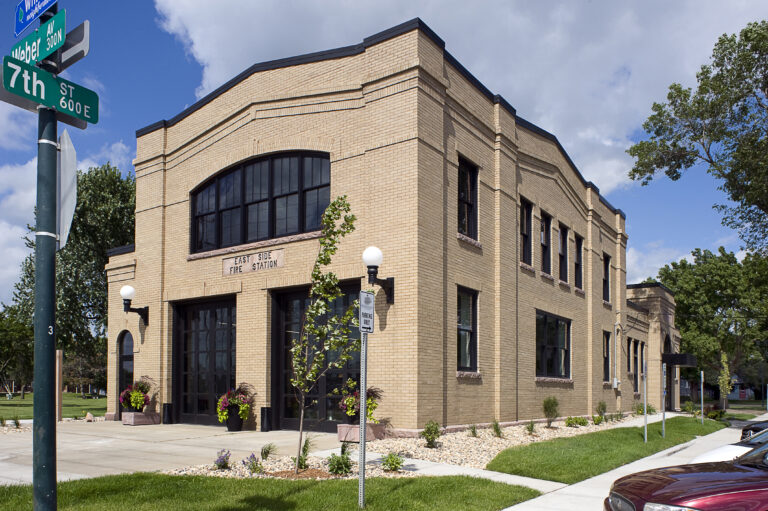 a building with a brick wall and a sidewalk in Sioux Falls, SD
