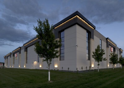 Modern distribution center exterior with exterior lighting at dusk